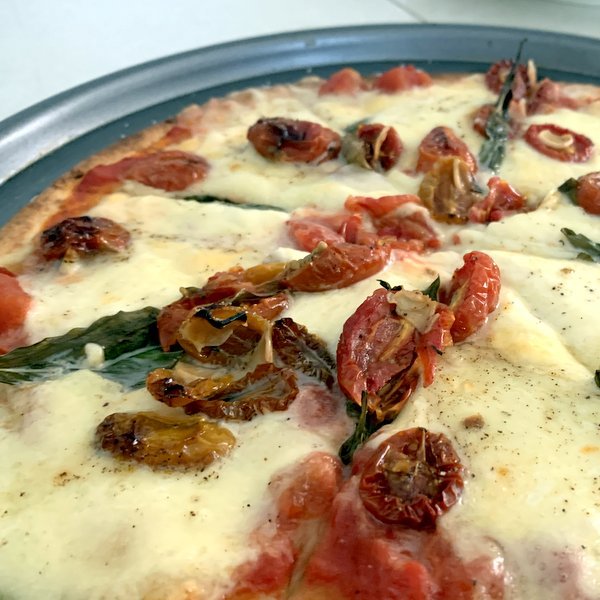 Roasted tomatoes used on a simple pizza.